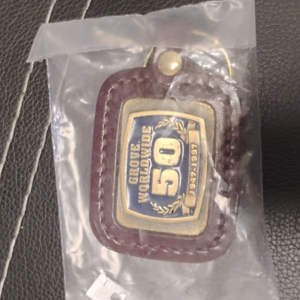 GROVE WORLDWIDE 50TH ANNIVERSARY COMMEMORATIVE KEYCHAIN CHARM MINT CONDITION